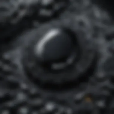 Close-up shot of a black gemstone highlighting its intricate patterns and textures.